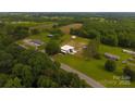 Expansive aerial view of the property showing lush greenery, multiple buildings, and ample land at 1028 Washburn Switch Rd, Shelby, NC 28150