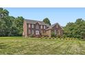 Beautiful two-story brick home surrounded by mature trees and a well-maintained lawn for a picturesque setting at 1185 Willow Creek Dr, Newton, NC 28658