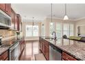 Kitchen island with granite countertops, stainless steel appliances, and hardwood floors at 1397 Tupelo Rd, Clover, SC 29710