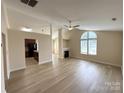 Bright living room with vaulted ceilings, fireplace, and lots of natural light at 1423 Napa Nw St, Concord, NC 28027