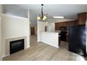 Inviting living space featuring an elegant fireplace and views into kitchen at 1423 Napa Nw St, Concord, NC 28027