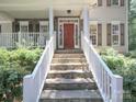 Welcoming front porch with stone stairs and white railings leading to a red front door at 155 Culpeze Rd, Mooresville, NC 28117