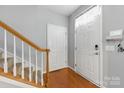 Inviting entryway features hardwood floors, stairs, and a storm door allowing natural light to flood the space at 158 Snead Rd, Fort Mill, SC 29715