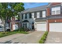 Well-maintained townhome showcasing a tidy lawn, attached garage, and welcoming front entrance at 158 Snead Rd, Fort Mill, SC 29715