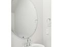 Modern powder room featuring a round mirror, silver faucet, and a white vessel sink at 1730 Old Rivers Rd, Concord, NC 28027