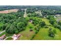 Aerial shot showcases a secluded home nestled among trees and greenery, providing a sense of privacy at 1783 Radio Station Rd, Newton, NC 28658