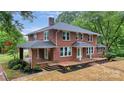 Elegant brick home featuring a classic design, covered porch, and symmetrical windows, exuding timeless charm at 1783 Radio Station Rd, Newton, NC 28658