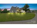 Charming two-story home boasts a manicured lawn and stone accents at 196 Sutters Mill Dr, Troutman, NC 28166