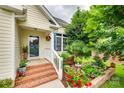 Inviting front porch featuring lovely flower beds and brick steps for a welcoming entrance at 2132 Cubla Ct, Rock Hill, SC 29732