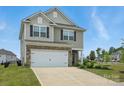 Charming two-story home featuring a stone-accented facade, attached garage, and well-maintained landscaping at 223 Haddonsfield Dr, Mooresville, NC 28115