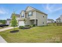Charming two-story home featuring a stone-accented facade, attached garage, and well-maintained landscaping at 223 Haddonsfield Dr, Mooresville, NC 28115