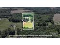 Aerial view of the property, showing boundary lines, a pond, fields, and mature tree coverage at 2932 Rant Drum Rd, Maiden, NC 28650