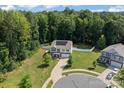 An aerial view of a two-story home highlighting its spacious yard, full fence, and location in a serene neighborhood at 301 Wheat Field Dr, Mount Holly, NC 28120