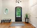 Inviting foyer features decorative front door, wood floors, and neutral paint scheme at 3394 Rainbow Dr, Waxhaw, NC 28173