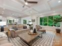 Open-concept living room with coffered ceilings and natural light from large windows at 3394 Rainbow Dr, Waxhaw, NC 28173