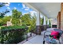 Relaxing covered patio offers a scenic view, stone pillars, and comfortable seating at 4009 Oxford Mill Rd, Waxhaw, NC 28173