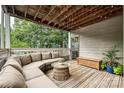 Relaxing covered deck featuring comfortable seating, string lights, and a wooden ceiling at 433-68 W 8Th St, Charlotte, NC 28202