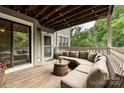 Cozy outdoor deck with comfortable sectional seating and a view of mature green trees at 433-68 W 8Th St, Charlotte, NC 28202