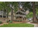 Charming multi-story condo with a brick facade, covered patios, landscaped yard, and a walkway at 433-68 W 8Th St, Charlotte, NC 28202