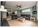 Inviting living room featuring hardwood floors and an open layout to the kitchen with black appliances at 433-68 W 8Th St, Charlotte, NC 28202