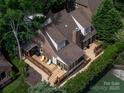 An aerial view of the home showcasing the deck, screened porch, lush backyard, and surrounding mature trees at 5104 Top Seed Ct, Charlotte, NC 28226