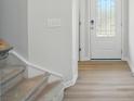 Bright entryway with hardwood floors, white trim, and a modern front door at 5334 Orchid Bloom Dr, Fort Mill, SC 29707