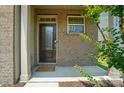 Stylish front door entrance with decorative glass, brick surround, and manicured landscaping at 5334 Orchid Bloom Dr, Fort Mill, SC 29707