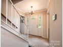 Inviting foyer with stairway, featuring a large front door with sidelights and transom window at 5516 Northwood Dr, Hickory, NC 28601