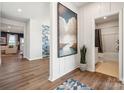 Inviting hallway with wood floors, leading to a cozy living space and a pristine bathroom at 6520 Alanbrook Rd, Charlotte, NC 28215