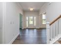 Bright foyer with hardwood floors, white trim, and a glass front door, offering a welcoming entrance at 7108 Hambright Rd, Huntersville, NC 28078
