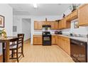 Spacious kitchen with wooden cabinets, updated appliances, and tile flooring at 7138 Somerset Springs Dr, Charlotte, NC 28262
