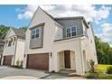 Bright, modern home with a two-car garage and inviting entry way features a beautiful, painted brick facade at 720 Flare Dr, Tega Cay, SC 29708