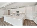 Bright, white eat-in kitchen features stainless appliances, granite countertops, and stylish backsplash at 720 Flare Dr, Tega Cay, SC 29708