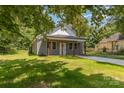 Angle of a cozy home with a well maintained lawn and mature trees at 925 4Th St, Statesville, NC 28677