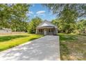 View of the house with a long driveway and green lawn at 925 4Th St, Statesville, NC 28677