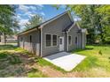 Gray vinyl siding and a concrete patio, with a yard at 925 4Th St, Statesville, NC 28677