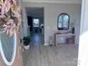 Bright foyer with light gray vinyl plank floors, stylish decor, and an open view to the kitchen at 9419 Silverdale Ln, Charlotte, NC 28269