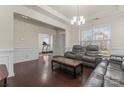 Inviting living room featuring hardwood floors, crown molding, and comfortable seating at 966 Nw Parkland Pl, Concord, NC 28027
