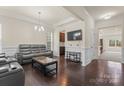 Comfortable living room with hardwood floors, detailed trim, and a wall-mounted TV at 966 Nw Parkland Pl, Concord, NC 28027