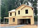 New construction home's exterior showcasing its framed structure, highlighting the design and building process at 9864 Quercus Ln, Huntersville, NC 28078