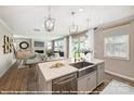 Bright kitchen with stainless steel appliances, island with sink, and open view to the living room at 9864 Quercus Ln, Huntersville, NC 28078