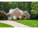 Charming two-story brick home with well-manicured lawn and attached two car garage at 10501 Olde Irongate Ln, Mint Hill, NC 28227