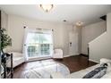 Sunlit living room with dark hardwood floors, bright white walls, and stylish furniture at 107 Golden Valley Dr, Mooresville, NC 28115
