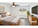 Comfortable bedroom with a queen-sized bed, neutral decor, and a window overlooking greenery at 108 Greenway View Ct, Mount Holly, NC 28120