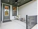 Cozy front porch featuring a chair, small table, and a stylish door at 123 Armstrong Rd, Belmont, NC 28012