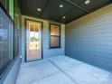 Covered patio perfect for outdoor living, featuring concrete flooring, a door, and a window at 123 Armstrong Rd, Belmont, NC 28012