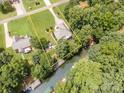Stunning aerial view of a waterfront home with a private dock and beautifully landscaped yard at 145 Waterwood Dr, Shelby, NC 28150