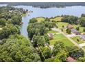 Aerial view of a waterfront property surrounded by lush greenery and serene lake waters at 145 Waterwood Dr, Shelby, NC 28150