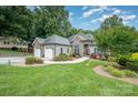 Beautiful landscaped front yard featuring a two-car garage and stone accents on the charming home at 145 Waterwood Dr, Shelby, NC 28150