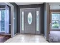 Welcoming foyer with tile flooring, sidelights, and decorative glass front door at 1633 Kiawah Ct, Gastonia, NC 28056